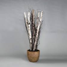 A decorative arrangement of artificial birch branches with white bark and dark branches, displayed in a round brown pot against a neutral gray background. Sold by The Stick And Stem